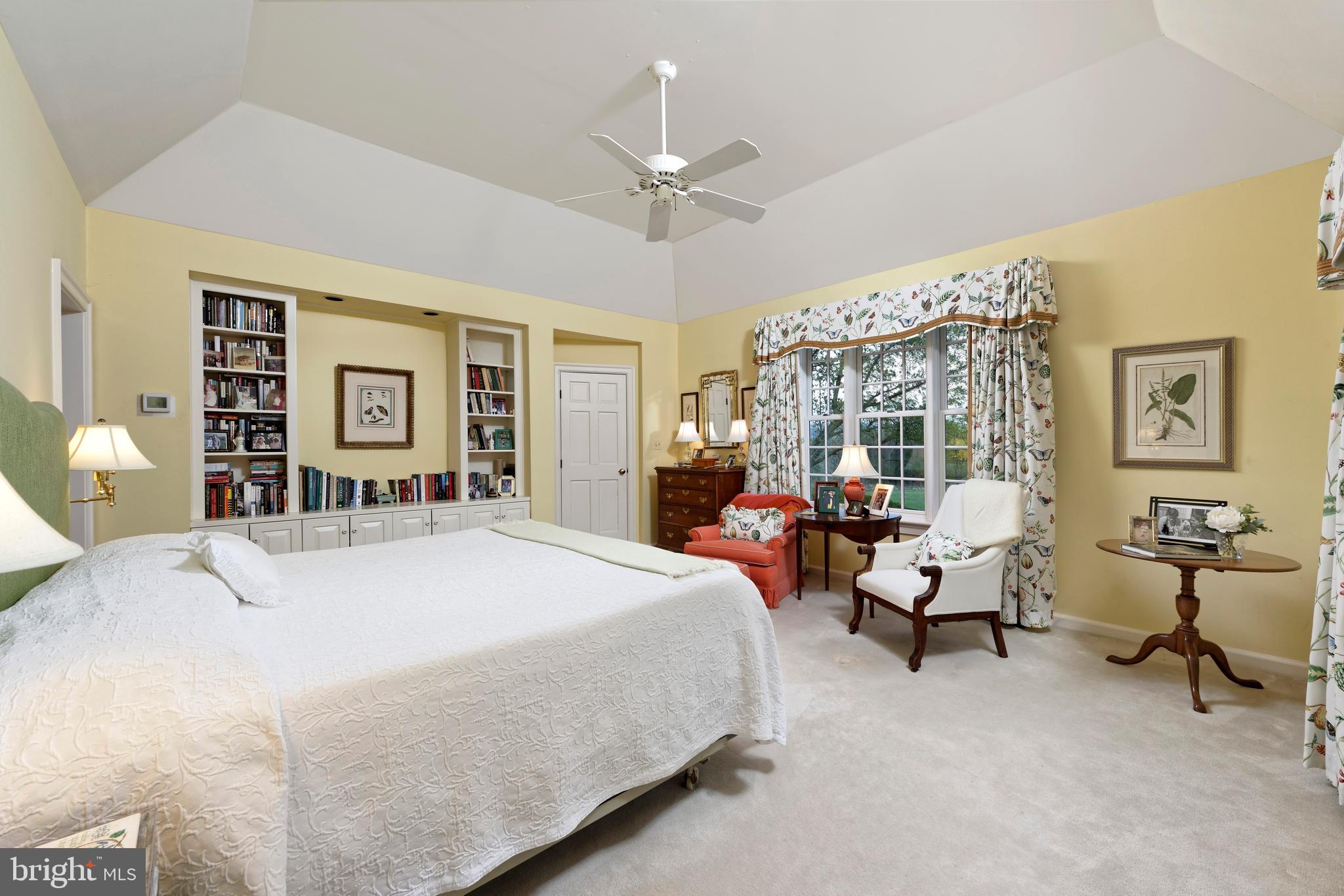 154 Clay Hill Road Boyce, VA 22620 - Photo 17 of 49 a spacious bedroom with a bed and a chandelier