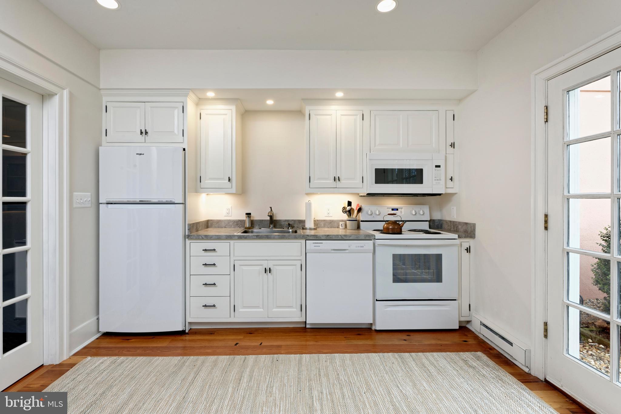 154 Clay Hill Road Boyce, VA 22620 - Photo 29 of 49 a kitchen with granite countertop white cabinets and white appliances