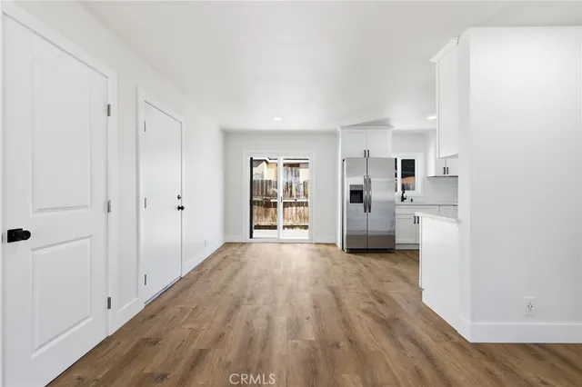 a view of a kitchen with wooden floor and windows