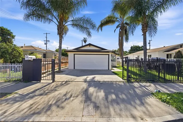 a view of a backyard with a garden and palm trees