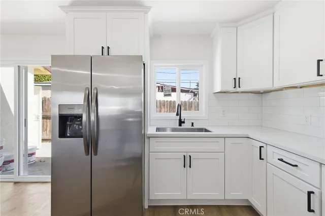 a kitchen with cabinets and a refrigerator