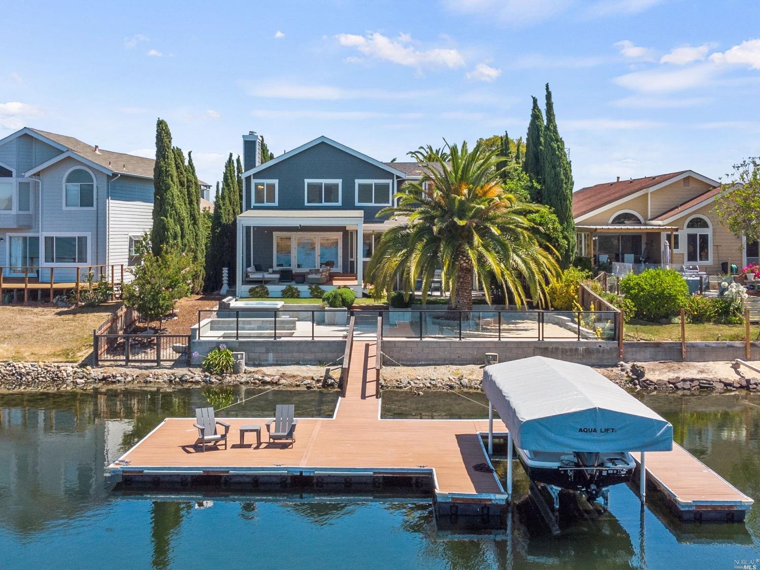 a swimming pool with outdoor seating and yard