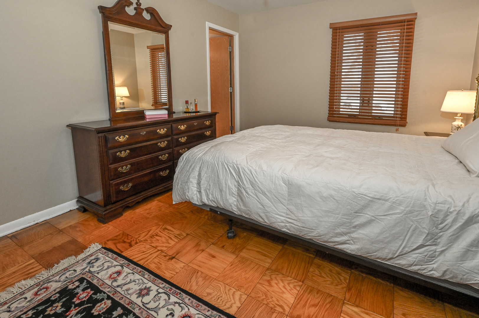81 Grange Road Elk Grove Village, IL 60007 - Photo 18 of 32 a bedroom with a bed and a mirror