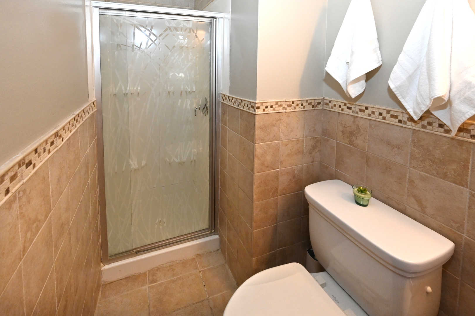 81 Grange Road Elk Grove Village, IL 60007 - Photo 21 of 32 a white toilet sitting next to a shower curtain