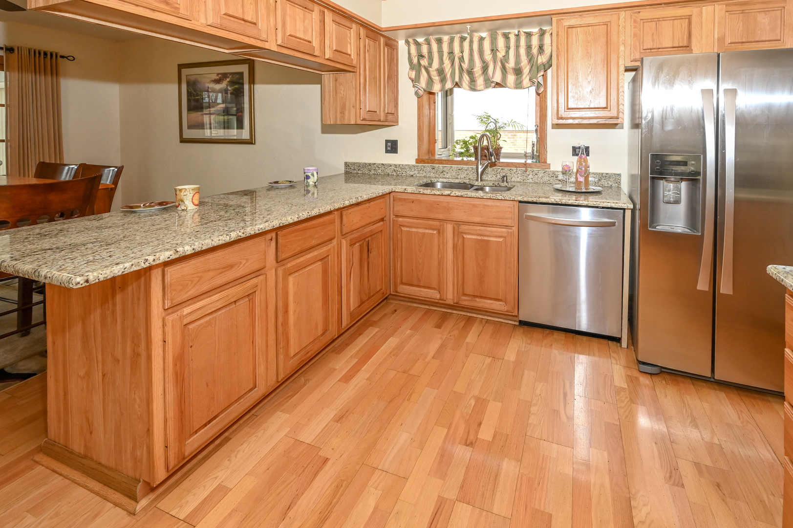 81 Grange Road Elk Grove Village, IL 60007 - Photo 7 of 32 a kitchen with stainless steel appliances granite countertop a sink and cabinets with wooden floor