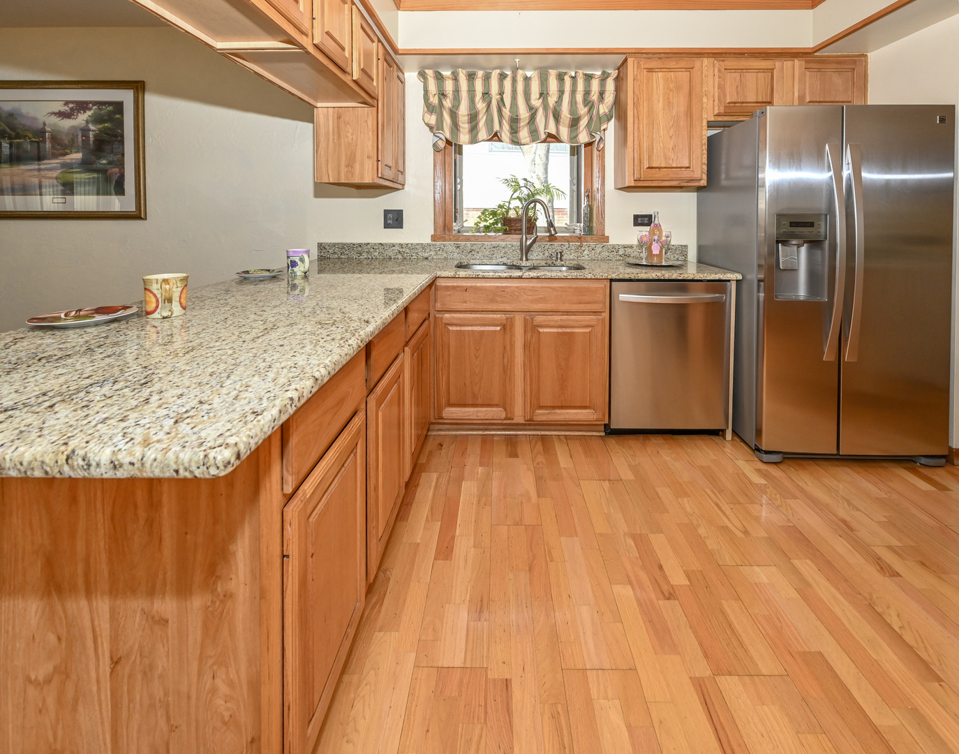 81 Grange Road Elk Grove Village, IL 60007 - Photo 8 of 32 a kitchen with stainless steel appliances granite countertop a sink a stove and a wooden floors