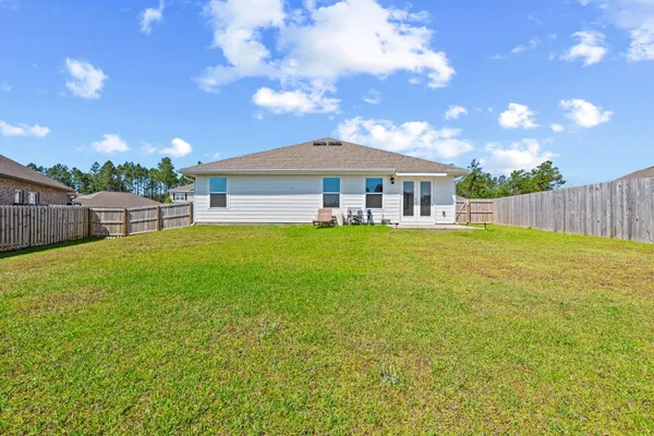 a view of a house with a yard and sitting area
