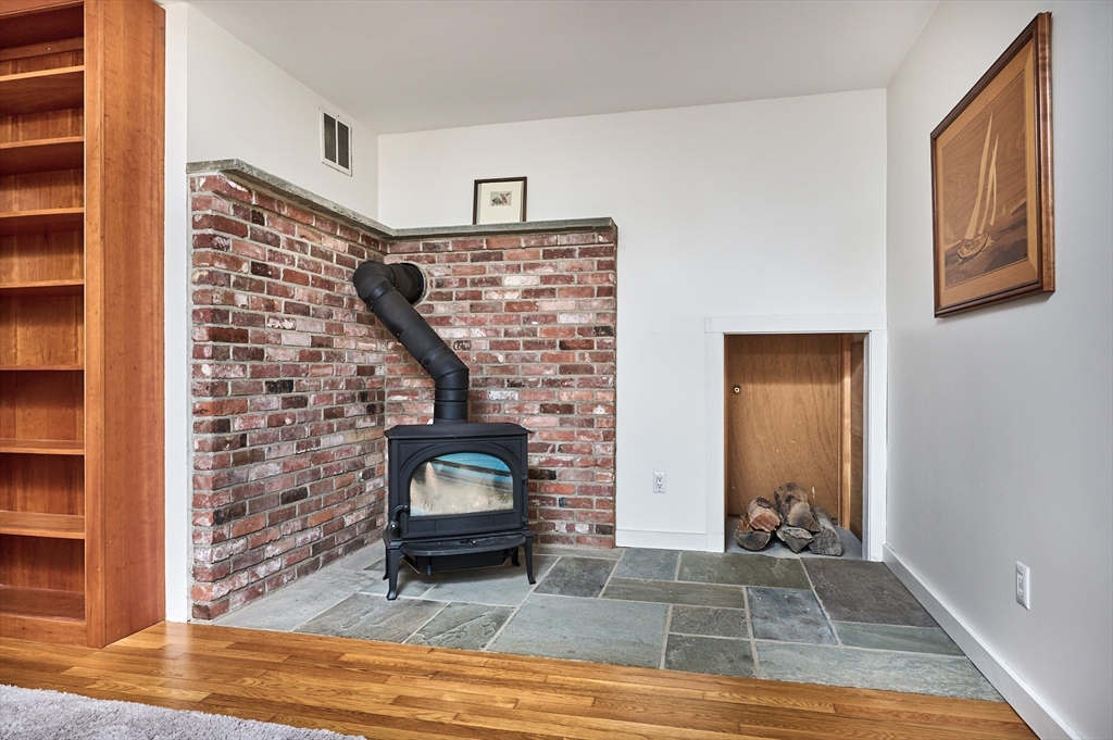 11 Shutesbury Road Leverett, MA 01054 - Photo 21 of 40 a view of a livingroom with wooden floor and a fireplace