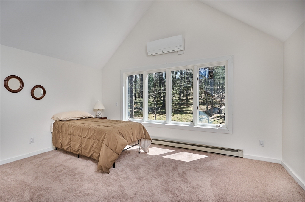 11 Shutesbury Road Leverett, MA 01054 - Photo 24 of 40 a bed sitting in a bedroom next to a window