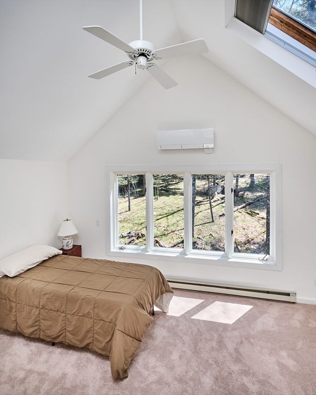11 Shutesbury Road Leverett, MA 01054 - Photo 26 of 40 a bedroom with a large bed and a large window