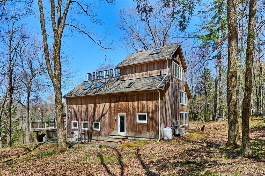 11 Shutesbury Road Leverett, MA 01054 - Photo 29 of 40 a front view of a house with large trees