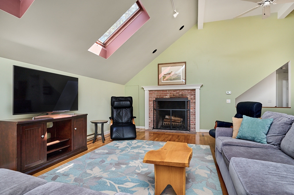 11 Shutesbury Road Leverett, MA 01054 - Photo 6 of 40 a living room with furniture a flat screen tv and a fireplace