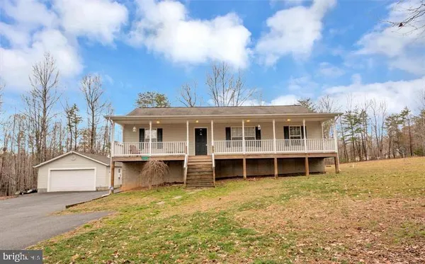 a view of a house with a yard and balcony
