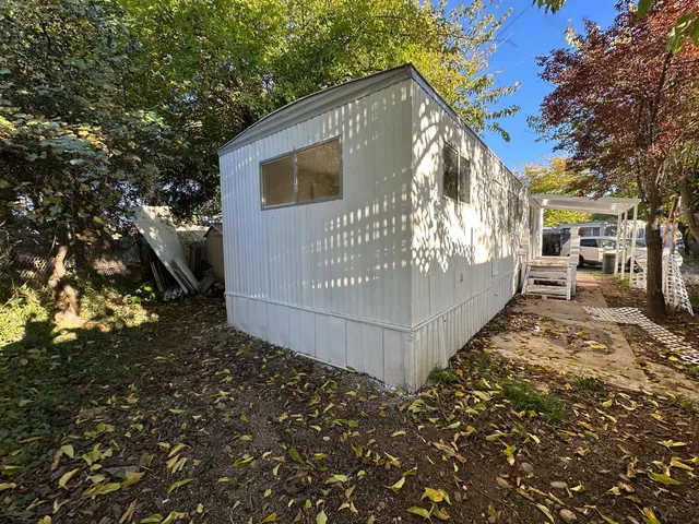 a kitchen with granite countertop a refrigerator and a sink