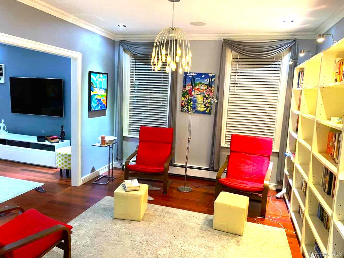 70-18 68th Street Queens, NY 11385 - Photo 4 of 12 a living room with furniture and a flat screen tv