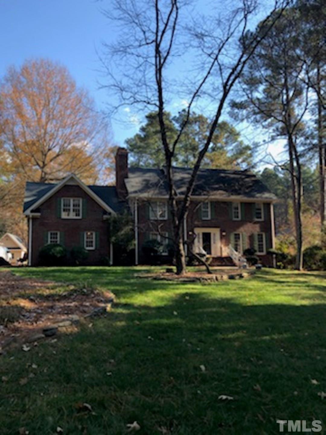 9408 Barton Creek Road Raleigh, NC 27615 - Photo 1 of 20 a front view of a house with swimming pool and garden