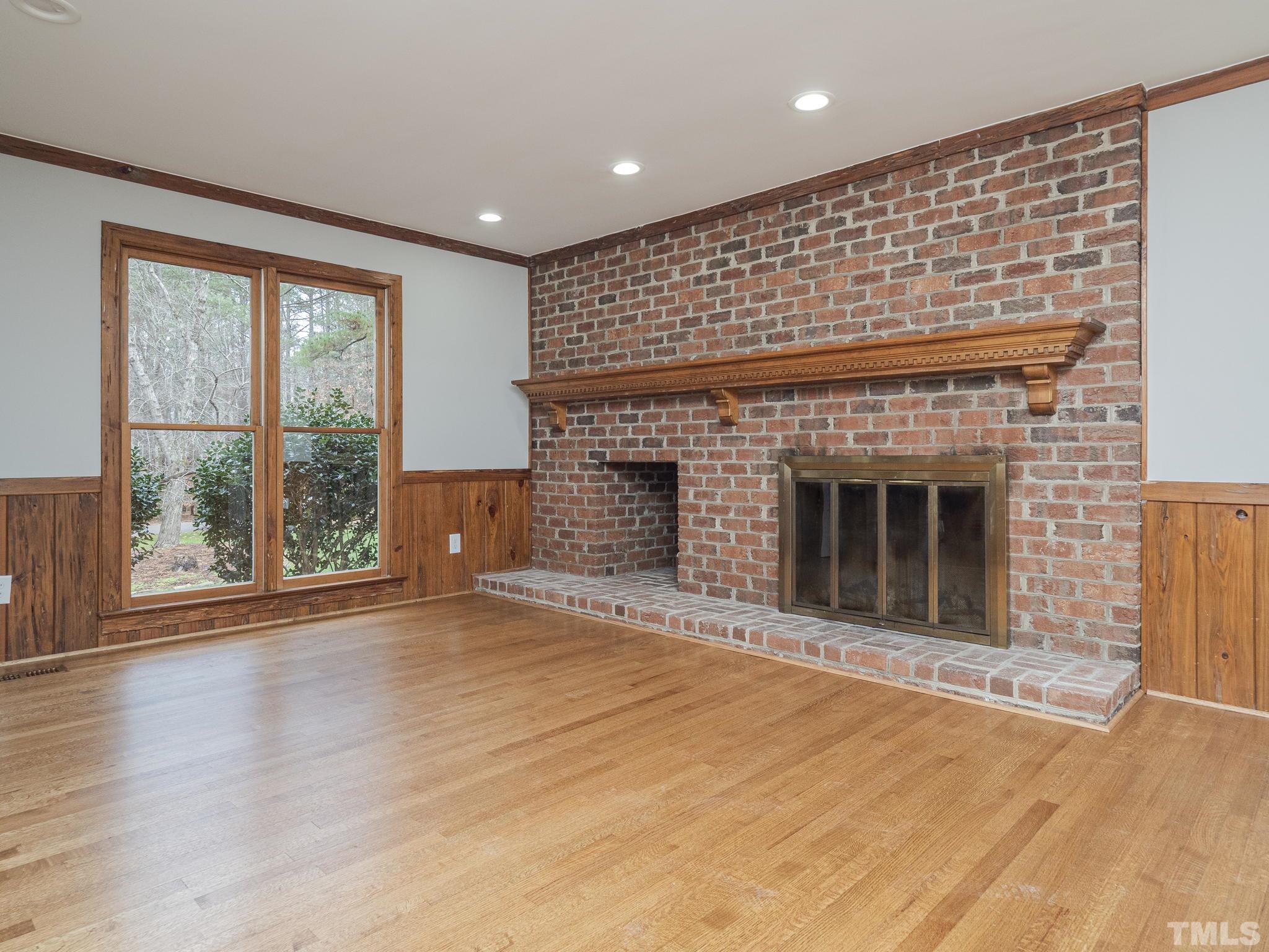 9408 Barton Creek Road Raleigh, NC 27615 - Photo 12 of 20 a view of an empty room with a fireplace and a window