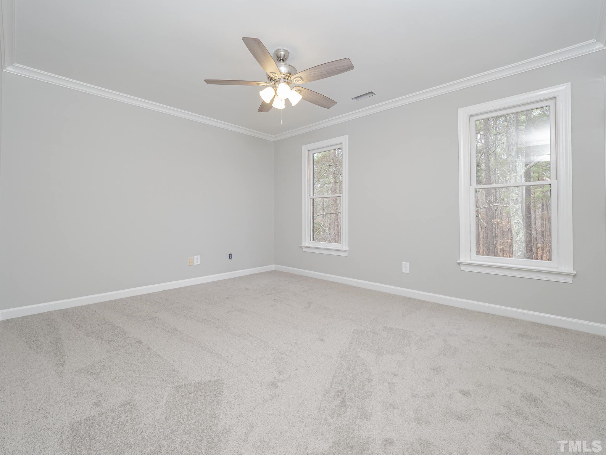 9408 Barton Creek Road Raleigh, NC 27615 - Photo 13 of 20 an empty room with windows and fan