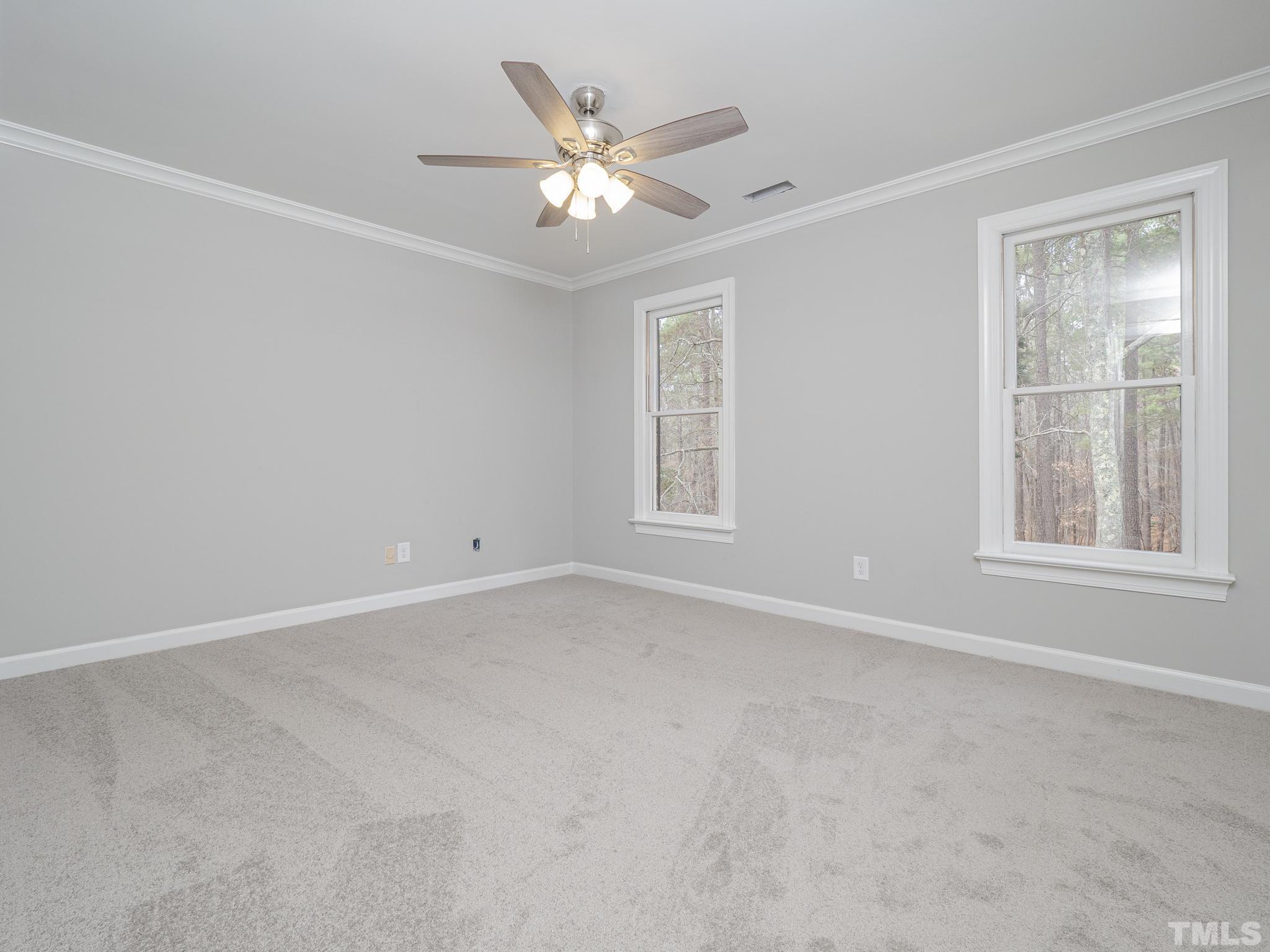 9408 Barton Creek Road Raleigh, NC 27615 - Photo 14 of 20 an empty room with windows and fan