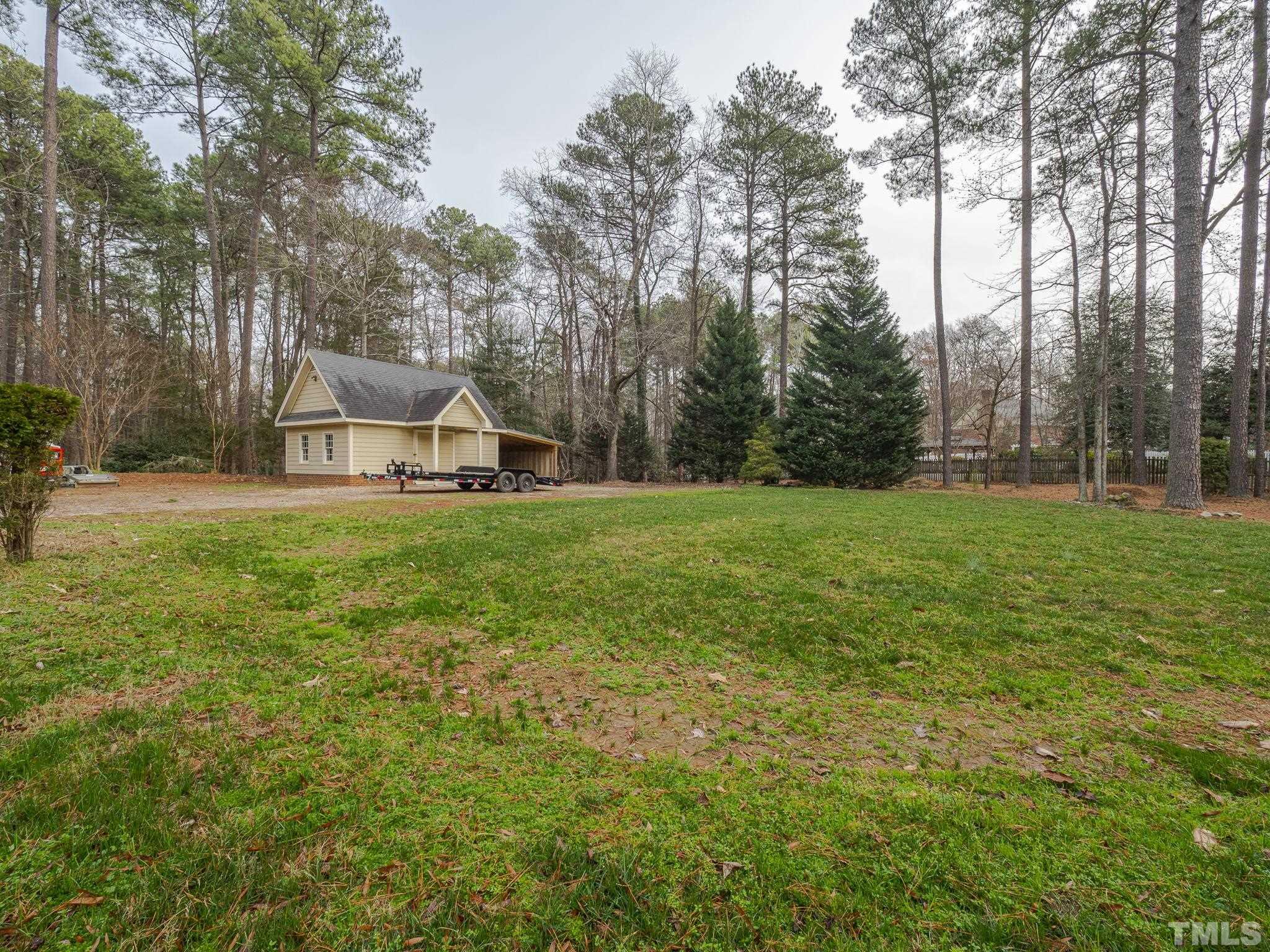 9408 Barton Creek Road Raleigh, NC 27615 - Photo 20 of 20 a view of a trees with a yard and trees