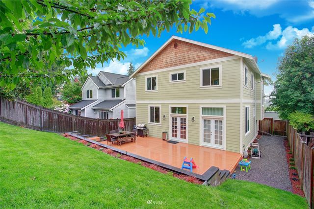 a view of a house with a yard patio and a slide