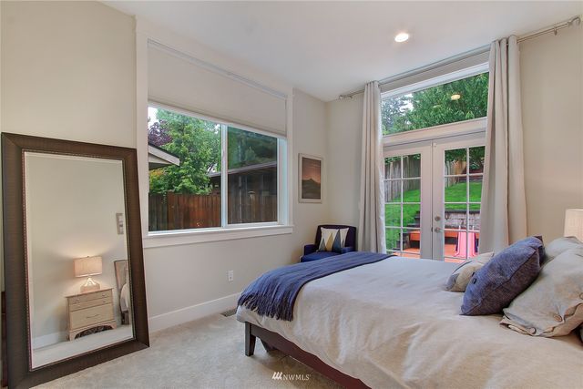 a large bed sitting in a bedroom next to a window