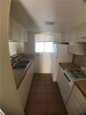 a white stove top oven and refrigerator