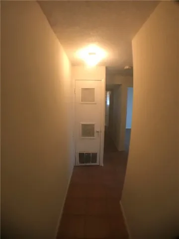 an entryway door with a hallway in a house