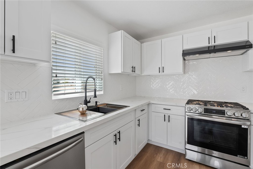 20631 Zuni Road Apple Valley, CA 92307 - Photo 11 of 25 a kitchen with a sink stove and cabinets
