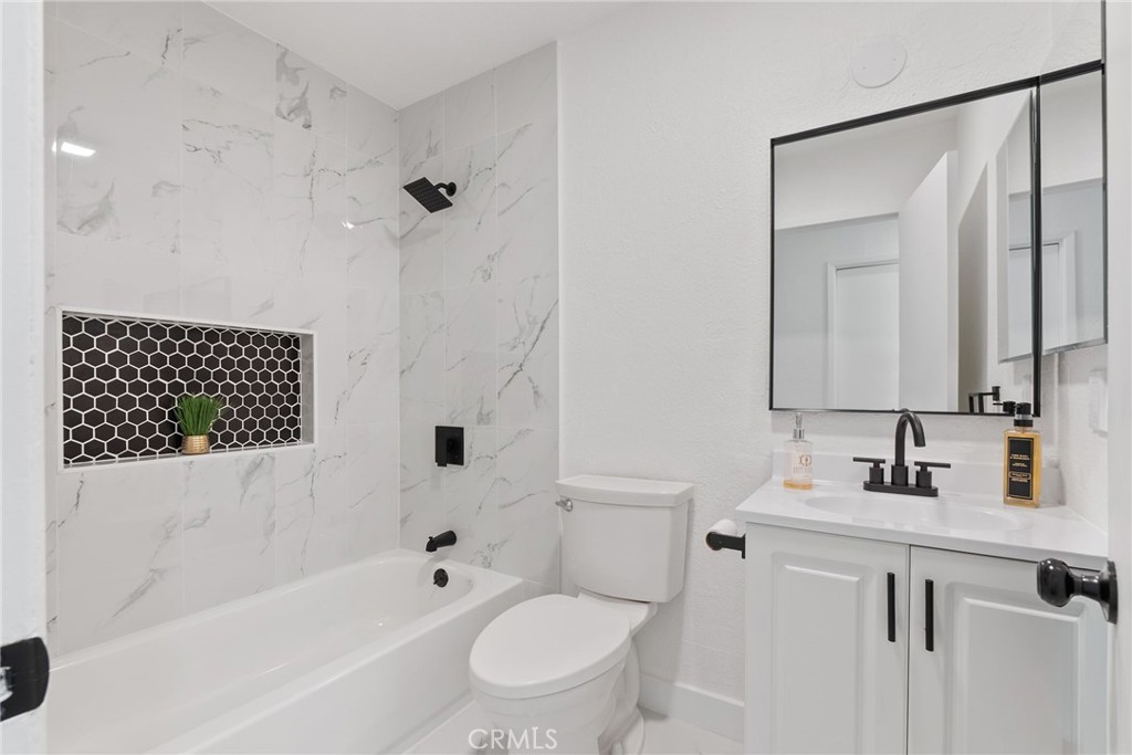 20631 Zuni Road Apple Valley, CA 92307 - Photo 14 of 25 a bathroom with a bathtub shower sink vanity and toilet