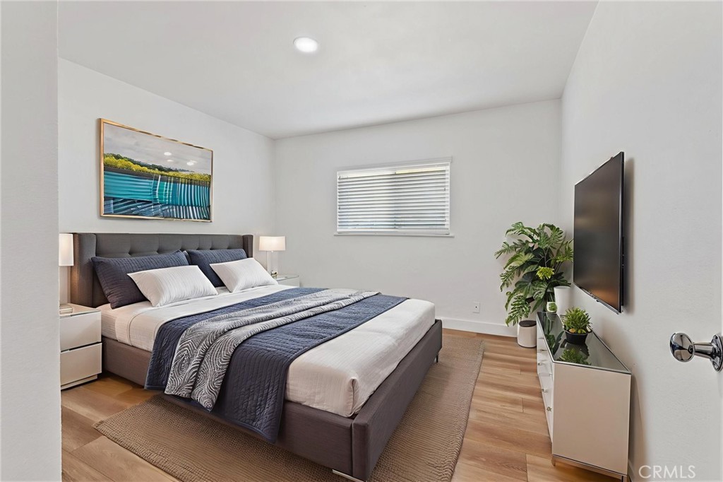 20631 Zuni Road Apple Valley, CA 92307 - Photo 18 of 25 a bedroom with bed and a potted plant