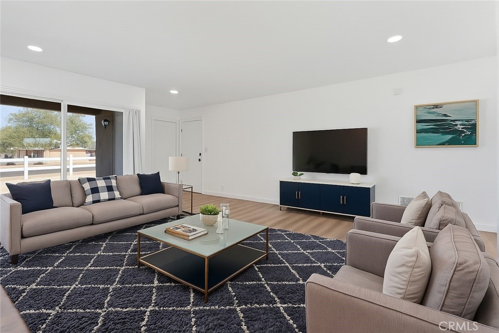 20631 Zuni Road Apple Valley, CA 92307 - Photo 5 of 25 a living room with furniture and a flat screen tv
