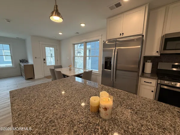 a view of a dining room with furniture and window