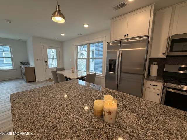 a view of a dining room with furniture and window