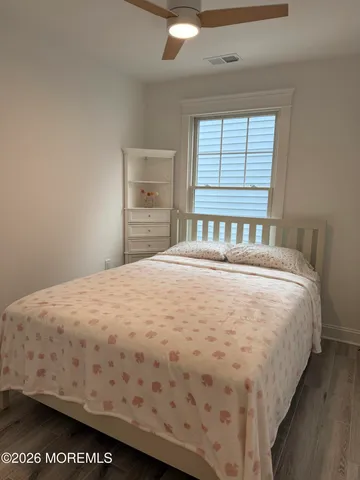 a bed sitting in a bedroom next to a window