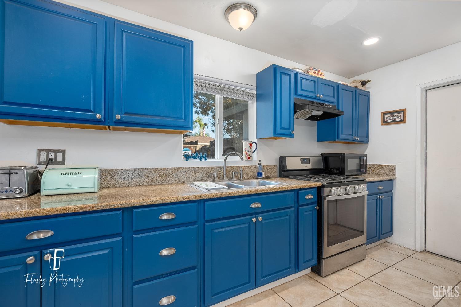 Undisclosed Address Bakersfield, CA 93304 - Photo 11 of 28 a kitchen with stainless steel appliances granite countertop wooden cabinets a sink and dishwasher