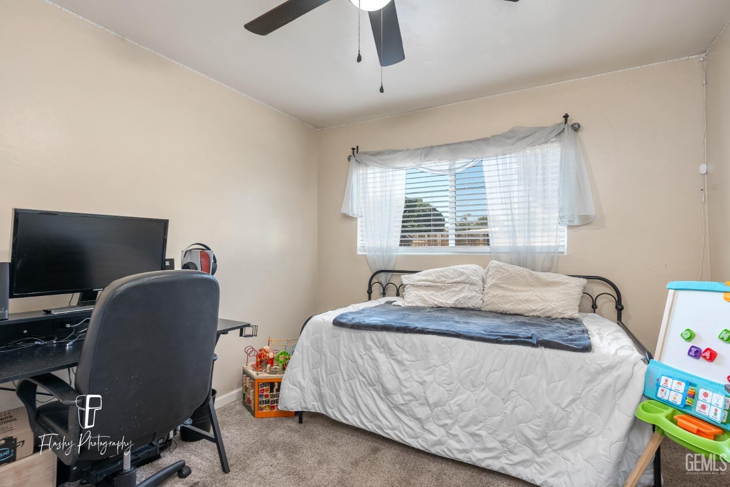 Undisclosed Address Bakersfield, CA 93304 - Photo 14 of 28 a bedroom with a bed and a window