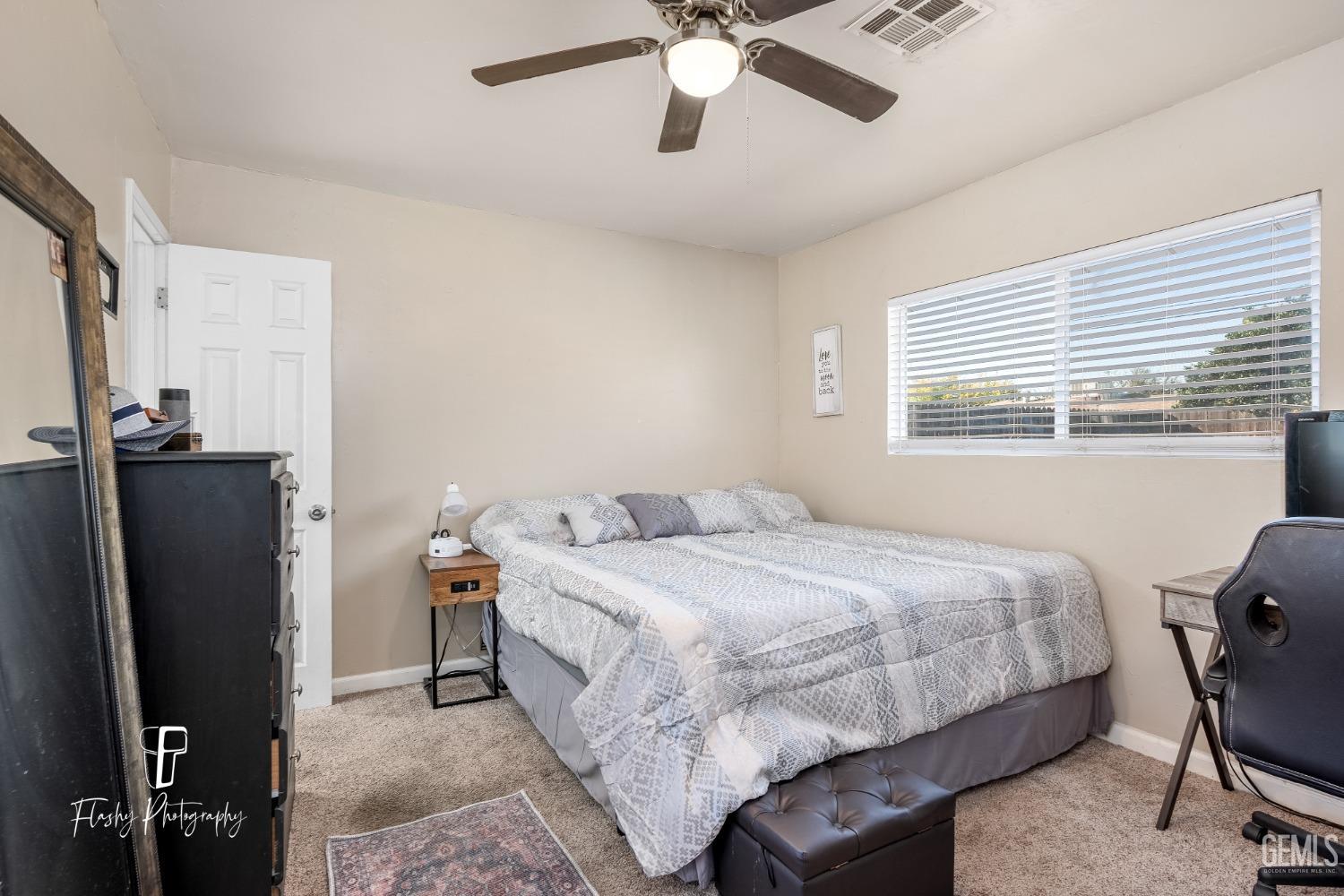 Undisclosed Address Bakersfield, CA 93304 - Photo 15 of 28 a bedroom with a bed dresser and a window