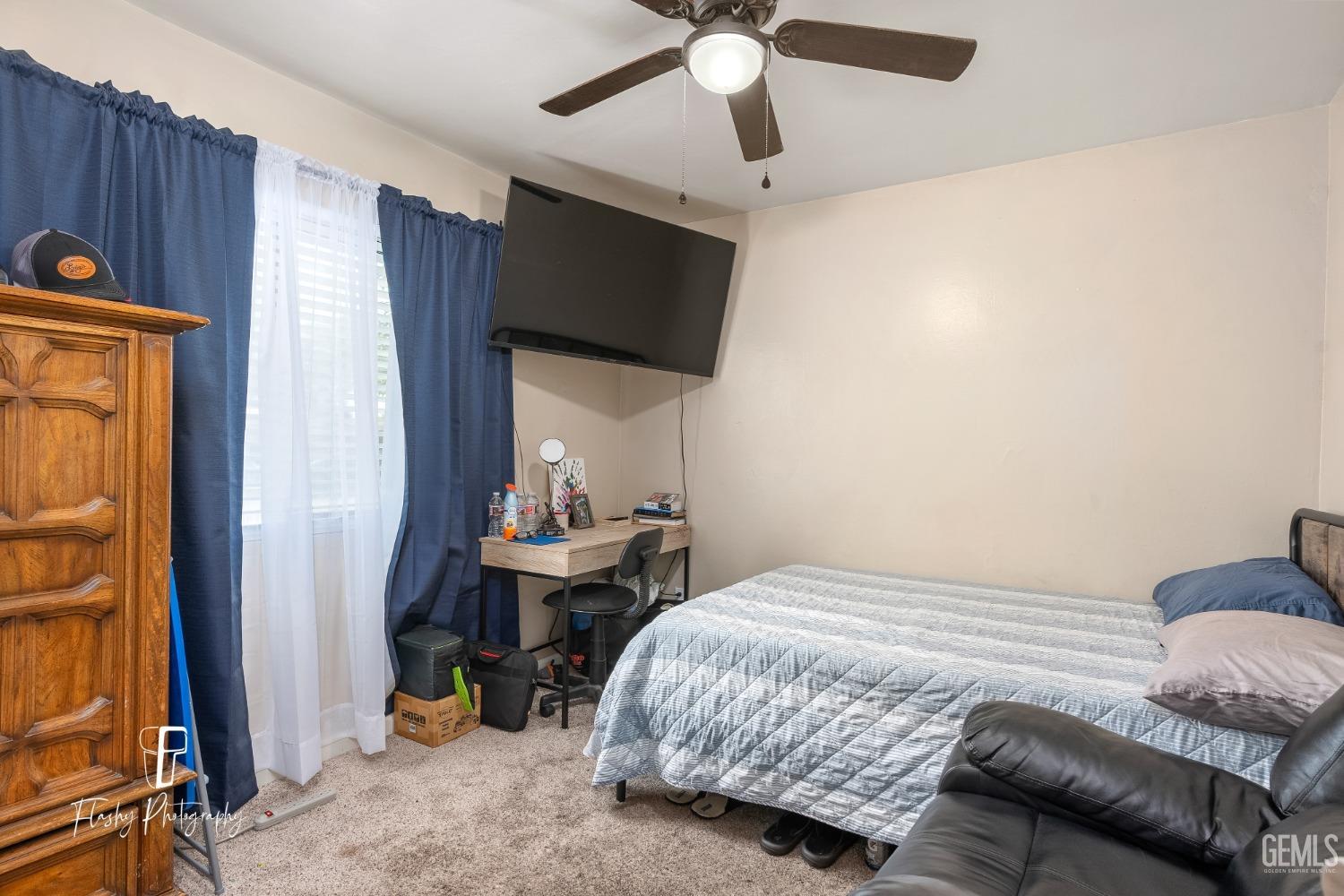 Undisclosed Address Bakersfield, CA 93304 - Photo 20 of 28 a bedroom with a bed a chair and potted plant on the dresser