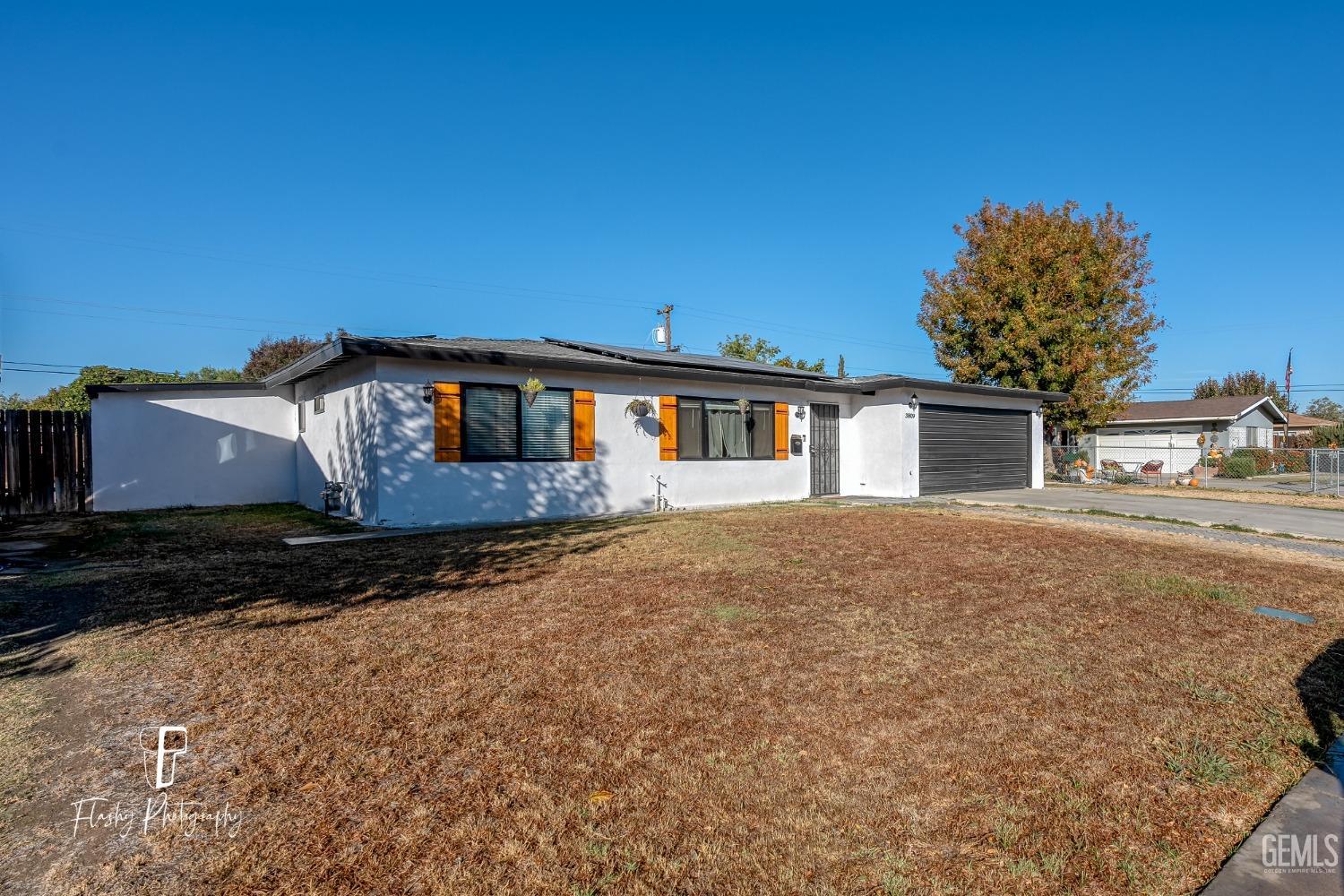Undisclosed Address Bakersfield, CA 93304 - Photo 2 of 28 front view of a house with a yard