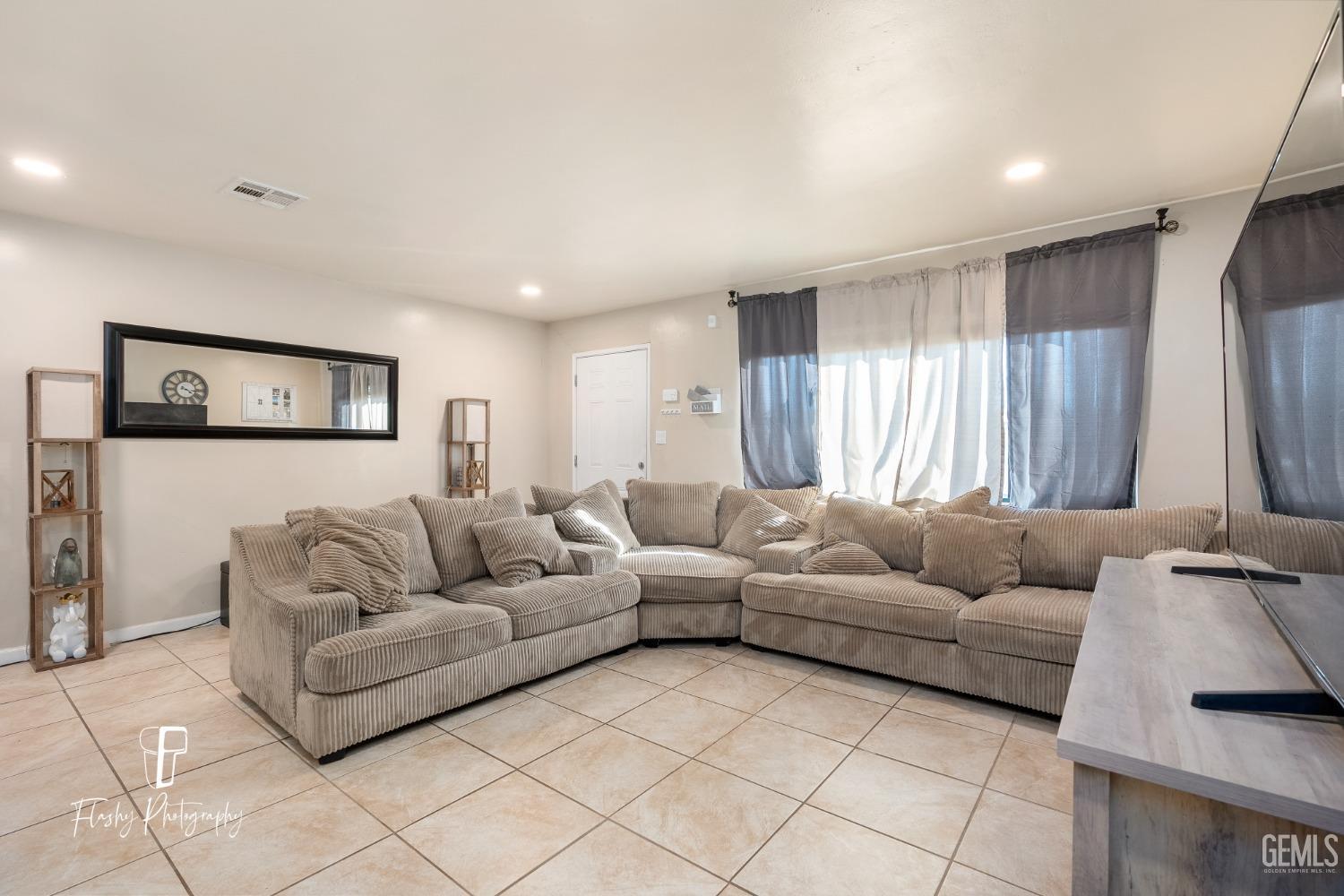 Undisclosed Address Bakersfield, CA 93304 - Photo 22 of 28 a living room with furniture and a couch