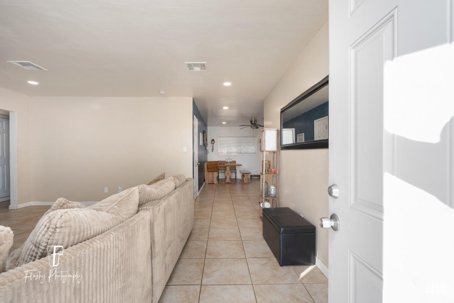 Undisclosed Address Bakersfield, CA 93304 - Photo 6 of 28 a living room with furniture and a table