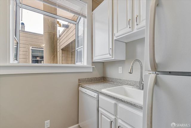 a kitchen with a stove and a refrigerator