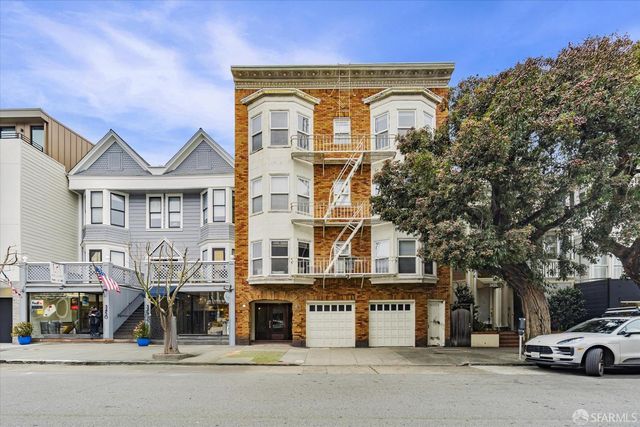 a front view of a residential apartment building with a street