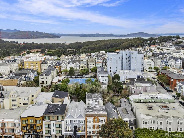 an aerial view of residential houses with city view