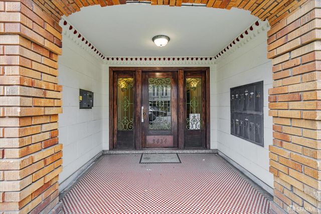 a view of a hallway with wooden floor and closet