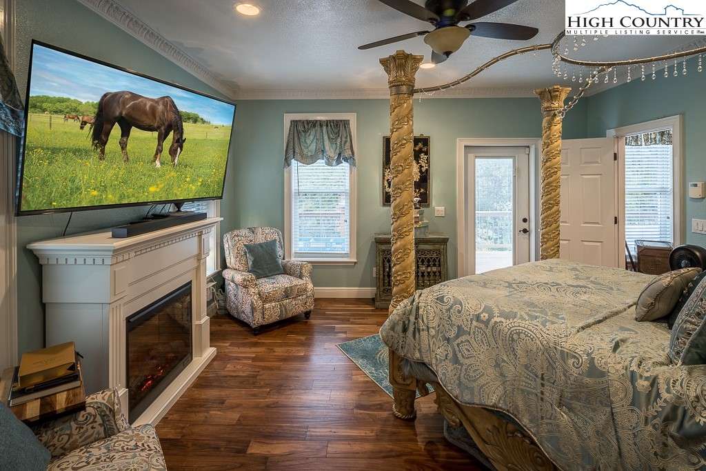 356 Upper Reach Drive Vilas, NC 28692 - Photo 15 of 49 a bedroom with a bed and a fireplace