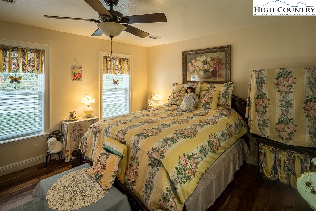 356 Upper Reach Drive Vilas, NC 28692 - Photo 22 of 49 a bedroom with a bed and wooden floor