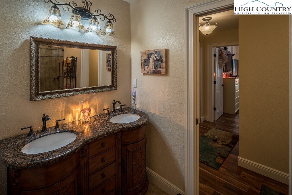 356 Upper Reach Drive Vilas, NC 28692 - Photo 23 of 49 a bathroom with a sink vanity and mirror