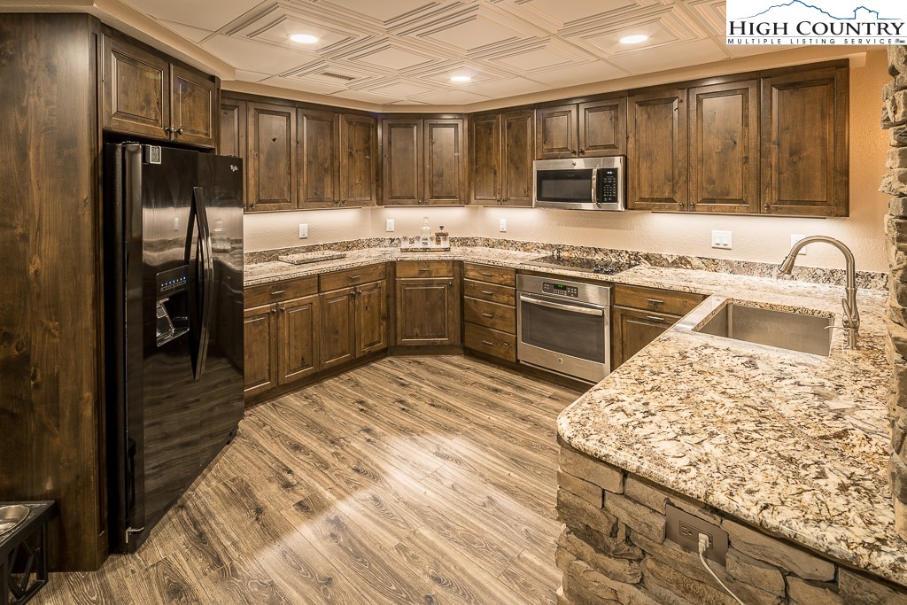 356 Upper Reach Drive Vilas, NC 28692 - Photo 26 of 49 a kitchen with granite countertop stainless steel appliances and wooden cabinets